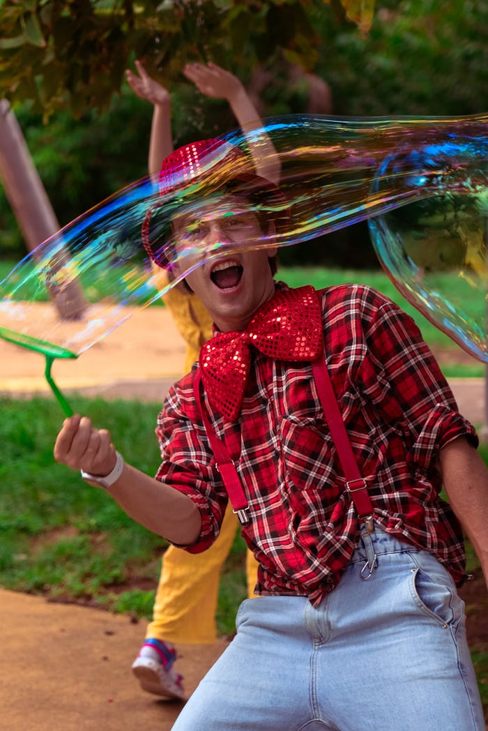 Man in a playful costume joyously creates large soap bubbles outdoors. Captured in dynamic motion.