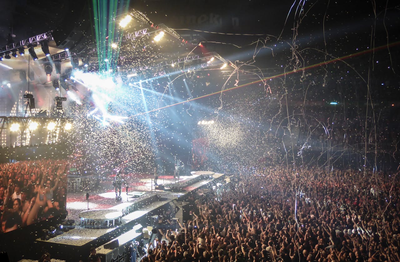 services-02 Vibrant concert scene with dynamic lighting, confetti, and a large enthusiastic crowd.