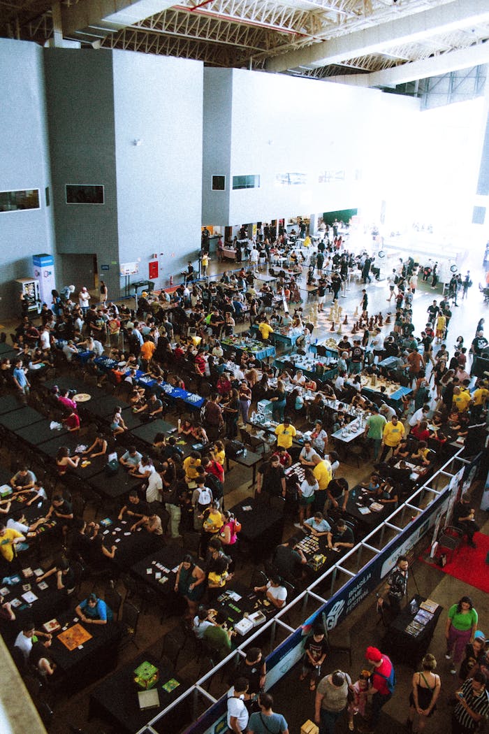 services-03 A bustling convention center filled with attendees at tables and walkways.