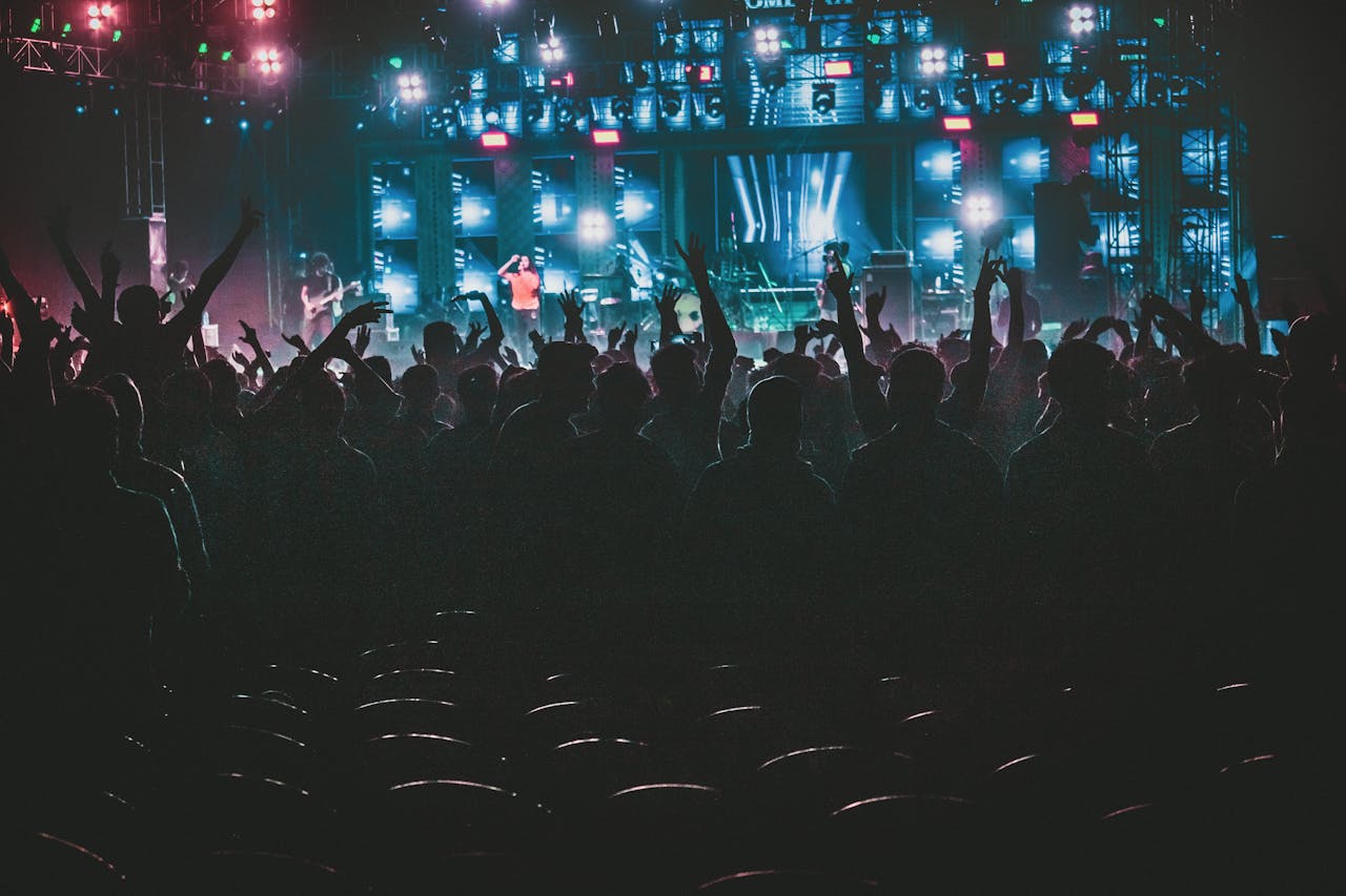 who-we-are Energetic crowd enjoying a live music concert with colorful lights in Contai, West Bengal, India.
